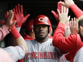 Cincinnati Reds' Yasiel Puig celebrates with teammates after hitting a two-run home run against the Chicago Cubs during the sixth inning of a baseball game Friday, May 24, 2019, in Chicago.