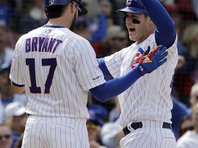 Chicago Cubs' Anthony Rizzo, right, celebrates with Kris Bryant after hitting a two-run home run during the fifth inning of a baseball game against the Miami Marlins, Thursday, May 9, 2019, in Chicago.
