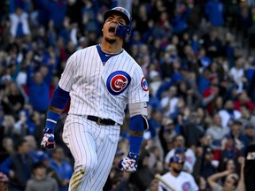 Chicago Cubs' Javier Baez reacts after hitting a home run during the eighth inning of the team's baseball game against the St. Louis Cardinals on Saturday, May 4, 2019, in Chicago.