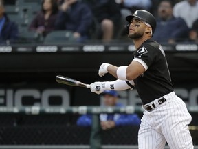 Chicago White Sox's Yoan Moncada watches his two-run home run off Kansas City Royals starting pitcher Glenn Sparkman during the first inning of a baseball game Wednesday, May 29, 2019, in Chicago.