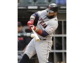 Cleveland Indians' Carlos Santana hits a single against the Chicago White Sox during the first inning of a baseball game in Chicago, Friday, May 31, 2019.