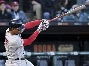 Boston Red Sox's Xander Bogaerts hits a two-run home run against the Chicago White Sox during the third inning of a baseball game in Chicago, Saturday, May 4, 2019.