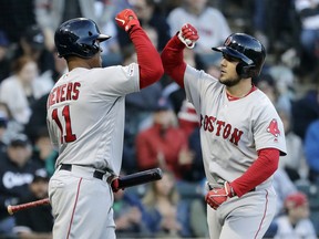 Boston Red Sox's Michael Chavis, right, celebrates with Rafael Devers after hitting a solo home run against the Chicago White Sox during the third inning of a baseball game in Chicago, Saturday, May 4, 2019.