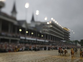 In this photo made with a tilt shift lens, Luis Saez rides Maximum Security across the finish line first during the 145th running of the Kentucky Derby horse race at Churchill Downs Saturday, May 4, 2019, in Louisville, Ky. Country House was declared the winner after Maximum Security was disqualified following a review by race stewards.