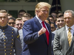 President Donald Trump pumps his fist as he departs after the presentation of the Commander-in-Chief's Trophy to the U.S. Military Academy at West Point football team, in the Rose Garden of the White House, Monday, May 6, 2019, in Washington.