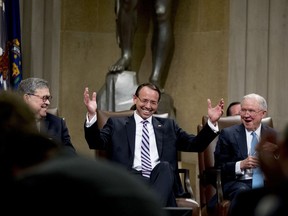 Attorney General William Barr, left, and former Attorney General Jeff Sessions, right, smile as Deputy Attorney General Rod Rosenstein, center, reacts to a speaker as he is honored with a farewell ceremony in the Great Hall at the Department of Justice in Washington, Thursday, May 9, 2019. Rosenstein is set to step down as Deputy Attorney General May 15.