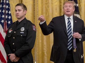 President Donald Trump speaks as he awards Ohio State police officer Alan Horujko of Columbus, Ohio, the Public Safety Officer Medal of Valor at a ceremony in the East Room of the White House in Washington, Wednesday, May 22, 2019.