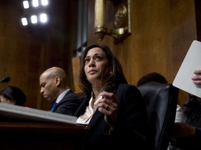 Democratic presidential candidates Sen. Cory Booker, D-N.J., left, and Sen. Kamala Harris, D-Calif., center, listen as Attorney General William Barr testifies during a Senate Judiciary Committee hearing on Capitol Hill in Washington, Wednesday, May 1, 2019, on the Mueller Report.