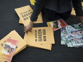 A volunteer prepares information packets for The Road to the Green New Deal Tour final event at Howard University in Washington, Monday, May 13, 2019. Presidential candidates Sen. Bernie Sanders, I-Vt., and Rep. Alexandra Ocasio-Cortez, D-N.Y., will address the rally.
