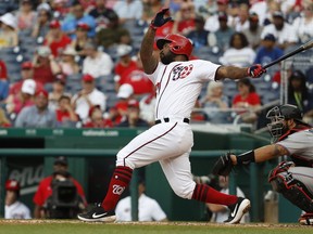 Washington Nationals' Howie Kendrick, left, follows through as he hits a home run against the Miami Marlins in the second inning of a baseball game, Sunday, May 26, 2019, in Washington.