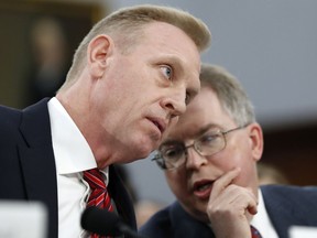Acting Defense Secretary Patrick Shanahan, left, listens to Acting Deputy Secretary David Norquist, Wednesday May 1, 2019, during a House Appropriations subcommittee on budget hearing on Capitol Hill in Washington.