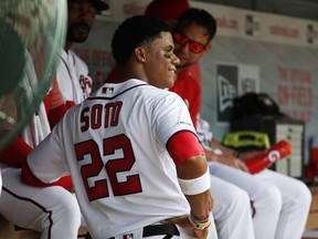 Washington Nationals left fielder Juan Soto (22) talks with teammates in the dugout during their baseball game against the Miami Marlins, Saturday, May 25, 2019, in Washington.
