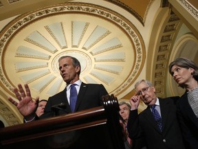 Senate Majority Whip John Thune, R-S.D., joined by Senate Majority Leader Mitch McConnell of Ky., second from right, and Sen. Joni Ernst, R-Iowa, speaks to members of the media following a Senate policy luncheon, Tuesday, April 30, 2019, on Capitol Hill in Washington.