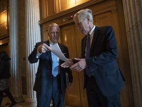 Sen. Dan Sullivan, R-Alaska, left, and Sen. Angus King, I-Maine, confer outside the Senate before weekly caucus meetings, at the Capitol in Washington, Tuesday, May 14, 2019.