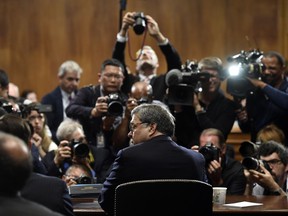 Attorney General William Barr is photographed as he sits down to testify before the Senate Judiciary Committee on Capitol Hill in Washington, Wednesday, May 1, 2019.