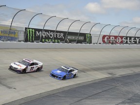 Denny Hamlin (11) leads Alex Bowman (88) during the NASCAR Cup Series auto race, Monday, May 6, 2019, at Dover International Speedway in Dover, Del.