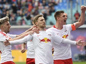 FILE - In this April 27, 2019 file photo, Leipzig's Emil Forsberg, 2nd right, celebrates after scoring a goal during the German Bundesliga soccer match between RB Leipzig and SC Freiburg in Leipzig, Germany. Fifty-four major titles compared to none, 119 years of existence against 10, some 290,000 club members versus 17 – the contrast between Bayern Munich and Leipzig could hardly be greater. The clubs meet in the German Cup final on Saturday, when Leipzig will bid for its first ever title and Bayern will hope to bring a happy end to a testing season with another domestic double.