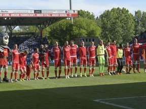 Players of the 1. FC Union Berlin from Germany's second Bundesliga celebrate after they win 3-0 against 1. FC Magdeburg in Berlin, Sunday, May 12, 2019.