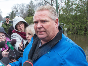 Ontario Premier Doug Ford speaks to reporters while inspecting flood damage in Constance Bay, near Ottawa.