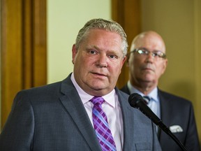 Ontario Premier Doug Ford and Minister of Municipal Affairs and Housing Steve Clark address media outside the Premier's office at Queen's Park in Toronto on May 27, 2019.