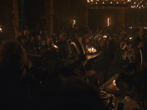 The winners of the Battle of Winterfell cheer with their horns of wine at a celebratory feast.