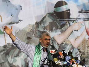 File - In this Friday, Oct. 21, 2011 file photo, Yehiyeh Sinwar, a founder of Hamas' military wing, talks during a rally in Khan Younis, southern Gaza Strip, . Sinwar left for talks with Egyptian officials Thursday after a new outbreak of violence, as Hamas accuses Israel of slowing down the implementation of Egyptian-mediated understandings aimed at easing the situation in the Palestinian enclave and paving the way for a cease-fire.