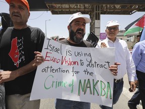 A man holds anti-Eurovision banner as Palestinian marked the 71st anniversary of their mass displacement during the 1948 war around Israel's creation. Demonstrations were held across the Israeli-occupied West Bank and the Gaza Strip on Wednesday to mark what the Palestinians call the "nakba," or "catastrophe."