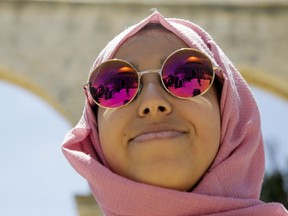 Dome of the Rock shrine reflects in sunglasses of a pilgrim during a holy month of Ramadan prayer in Jerusalem, Friday, May 10, 2019.