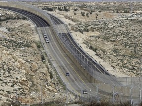 FILE - This Jan. 10, 2019 file photo, shows a newly opened segregated West Bank highway near Jerusalem. Israel's government went on a spending binge in its West Bank settlements following the election of President Donald Trump, according to official data obtained by The Associated Press. Both supporters and detractors of the settlement movement have previously referred to a "Trump effect," claiming the president's more lenient approach to the settlements would result in additional West Bank construction.