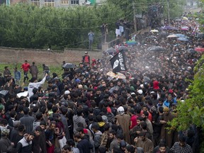Kashmiri villagers carry the body of Zakir Musa, a top militant commander linked to al-Qaida, as it rains during his funeral procession in Tral, south of Srinagar, Indian controlled Kashmir, Friday, May 24, 2019. Musa was killed Thursday evening in a gunfight after police and soldiers launched a counterinsurgency operation in the southern Tral area, said Col. Rajesh Kalia, an Indian army spokesman.