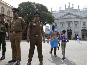 In this Sunday, May 12, 2019, photo, Sri Lankan soldiers stand guard at the entrance to Good Shepherd convent and the St. Benedict's college in Colombo, Sri Lanka. Catholic officials and parents in Sri Lanka are hopeful that church-run schools will begin to reopen soon for the first time since April's devastating Easter Sunday attacks on churches and hotels.