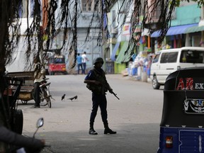 A Sri Lankan naval soldier stands guard at a road leading to a closed market on May Day in Colombo, Sri Lanka, Wednesday, May 1, 2019. Sri Lanka's major political parties called off traditional May Day rallies due to security concerns following the Easter bombings that killed more than 250 people and were claimed by militants linked to the Islamic State group.
