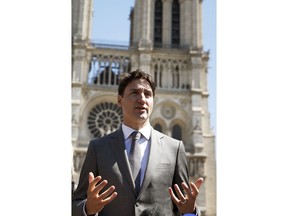 Canadian Prime Minister Justin Trudeau adresses reporters after visiting Notre Dame cathedral in Paris, Wednesday, May 15, 2019. Trudeau is in Paris for a meeting with World leaders and tech bosses to make a joint push to eliminate acts of violent extremism from being shown online.