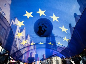 Students transport an inflated globe and a flag of the European Union through the streets of Muenster, northwestern Germany, in a May 24, 2019, rally for action on climate change.