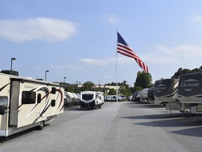 In this undated handout photo provided by Camping World, an American flag blows in the wind at Gander RV, in Statesville, N.C. Businessman and reality television star Marcus Lemonis says he'll go to jail before he removes a huge American flag flying at a recreational vehicle store that his company owns and that's the subject of a lawsuit because of its size.