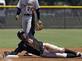 New York Yankees' Didi Gregorius calls for time out after sliding into third base during the first inning of a Gulf Coast League baseball game Monday, May 20, 2019, in Tampa, Fla. Gregorius is playing for the first time since having Tommy John surgery.
