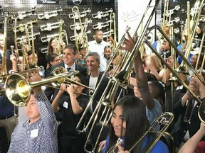Fifty students surround Max Schachter and Fred Schiff to blast a B-flat on their new Alex Tribute Trombones Saturday, May 11, 2019 at All County Music in Tamarac, Fla. Fifty special trombones have been given out to band students throughout Florida in honor of 14-year-old Alex Schachter, who was a trombone player in the marching band at Marjory Stoneman Douglas High School and who died in the Parkland high school shooting.