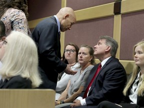 Broward County prosecutor Mike Satz speaks with Debbi Hixon, the widow of murder victim Chris Hixon, who was in court for a hearing for Parkland school shooting suspect Nikolas Cruz at the Broward Courthouse in Fort Lauderdale, Fla., Wednesday May 1, 2019. Cruz was in court for a motion by the Public Defender's Office to withdraw from the case due to Cruz receiving an inheritance that can be used to pay for a private attorney.Nikolas Cruz, who faces the death penalty if convicted. Cruz is accused of killing 17 and wounding 17 in the February 2018 mass shooting at Marjory Stoneman Douglas High School in Parkland, Fla.