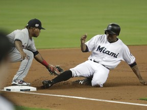 Miami Marlins' Curtis Granderson, right, is tagged out at third by Cleveland Indians third baseman Jose Ramirez during the first inning of a baseball game Wednesday, May 1, 2019, in Miami.
