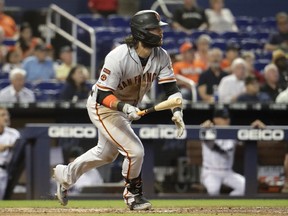 San Francisco Giants' Brandon Crawford watches after hitting a ground rule double to score two runs during the eighth inning of a baseball game against the Miami Marlins, Thursday, May 30, 2019, in Miami.