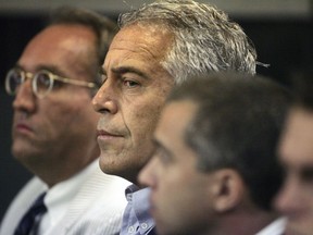 FILE- In this July 30, 2008, file photo, Jeffrey Epstein is in custody in West Palm Beach, Fla. Federal prosecutors want to meet with once-underage victims of wealthy financier and convicted sex offender Epstein before deciding whether to open up a non-prosecution agreement reached over a decade ago. Prosecutors said in court filings Friday, May 10, 2019, that victim input is essential in deciding how to proceed.