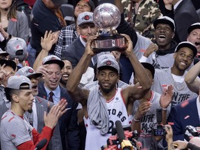 Toronto Raptors Kawhi Leonard hoists the trophy after the Raptors won theEastern Conference Final against the Milwaukee Bucks Toronto on Saturday, May 25, 2019.