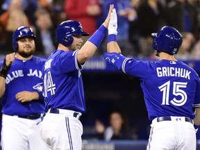 Toronto Blue Jays left fielder Randal Grichuk (15) celebrates with Justin Smoak (14) after Grichuk hit a three run home run to centre fiield during first inning American League baseball action against the Chicago White Sox in Toronto on Friday, May 10, 2019.