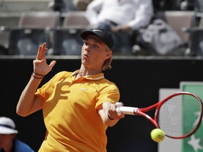 FILE - In this Thursday, May, 16, 2019 file photo, Canada's Denis Shapovalov returns the ball to Serbia's Novak Djokovic at the Italian Open tennis tournament, in Rome. It's typically Canadian that Denis Shapovalov, Felix Auger-Aliassime and Bianca Andreescu are each children of immigrants. What's not typical is that they have all simultaneously broken into the world's elite ranks of tennis players _ and will all be worth watching when the French Open begins Sunday.