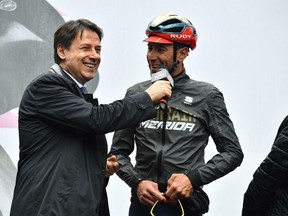 Italian Premier Giuseppe Conte shares a laugh with Vincenzo Nibali prior to the fifth stage of the Giro D'Italia, tour of Italy cycling race, from Frascati to Terracina, Wednesday, May 15, 2019.