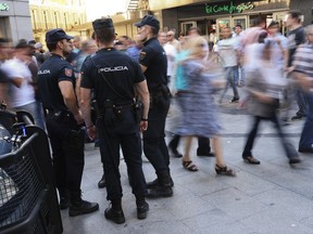 National Police officers stand guard near Sol square the day before of the Champions League soccer final in downtown Madrid, Spain, Friday, May 31, 2019. Madrid will be hosting the final again after nearly a decade, but the country's streak of having at least one team playing for the European title ended this year after five straight seasons, giving home fans little to cheer for when Liverpool faces Tottenham at the Wanda Metropolitano Stadium on Saturday.