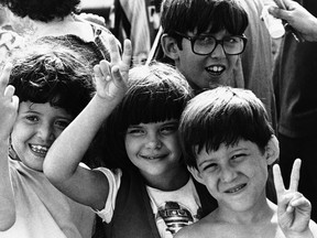 FILE - In this May 21, 1980, file photo, Cuban refugee children flash victory signs after their arrival in Key West, Fla. Throughout history, the United States has used all sorts of physical or mental exams for immigrants seeking just to get into the country outside of becoming a citizen.