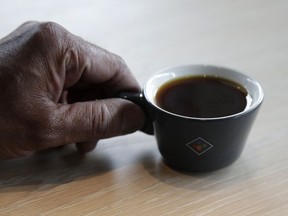 Klatch Coffee owner Bo Thiara holds a cup of Elida Natural Geisha coffee at his shop in San Francisco, Wednesday, May 15, 2019. The California cafe is brewing up what it calls the world's most expensive coffee - at $75 a cup. Klatch Coffee Roasters is serving the exclusive brew, the Elida Natural Geisha 803, at its branches in Southern California and San Francisco.