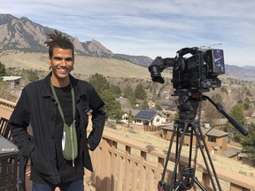 In this undated photo provided by lawyer Siddhartha Rathod, Zayd Atkinson poses for a photo. Atkinson was picking up trash outside his dormitory when a white police officer in Boulder, Colo., detained him in March, 2019. The officer, John Smyly, resigned this week under an agreement with city officials who found he had violated department policies.