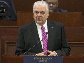 FILE - In this Jan. 16, 2019 file photo, Nevada Gov. Steve Sisolak delivers his State of the State address from the Assembly Chambers of the Nevada Legislature in Carson City, Nev. Nevada will not join other US states that have pledged their Electoral College votes to the presidential candidate who wins the national popular vote. Democratic Gov. Steve Sisolak announced Thursday, May 30, 2019, he had vetoed the measure.